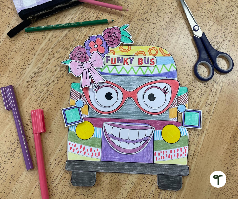 Funky school bus craft on table with pens and scissors.