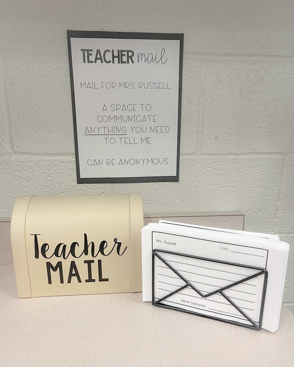 Teacher mailbox on table with lined paper for kids to fill out. 