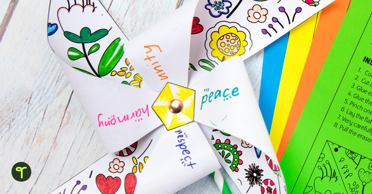 Peace Day pinwheel on table with colorful paper.