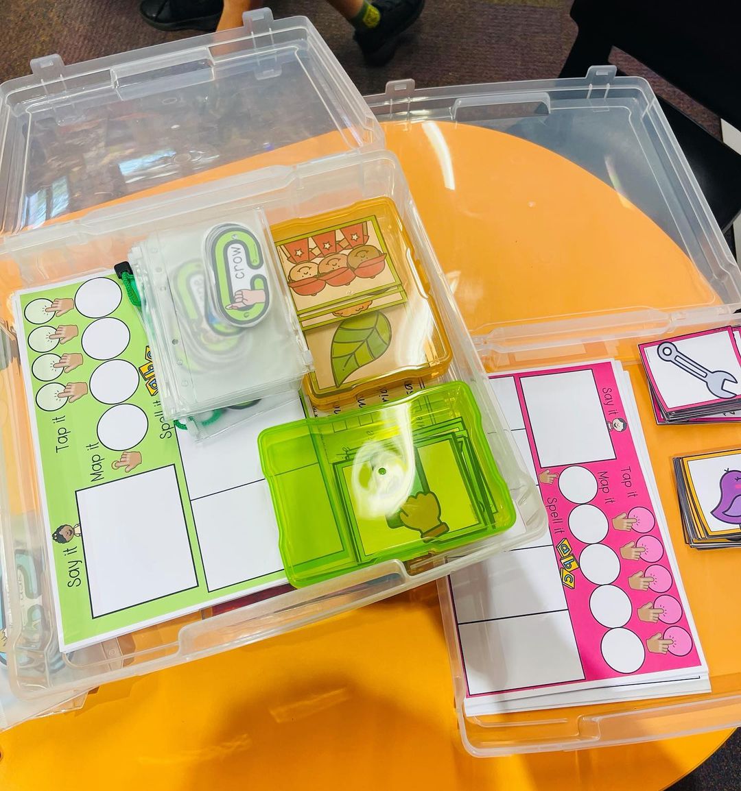 Kmart hacks for teachers: phonics teaching resources stacked in a clear plastic container. 