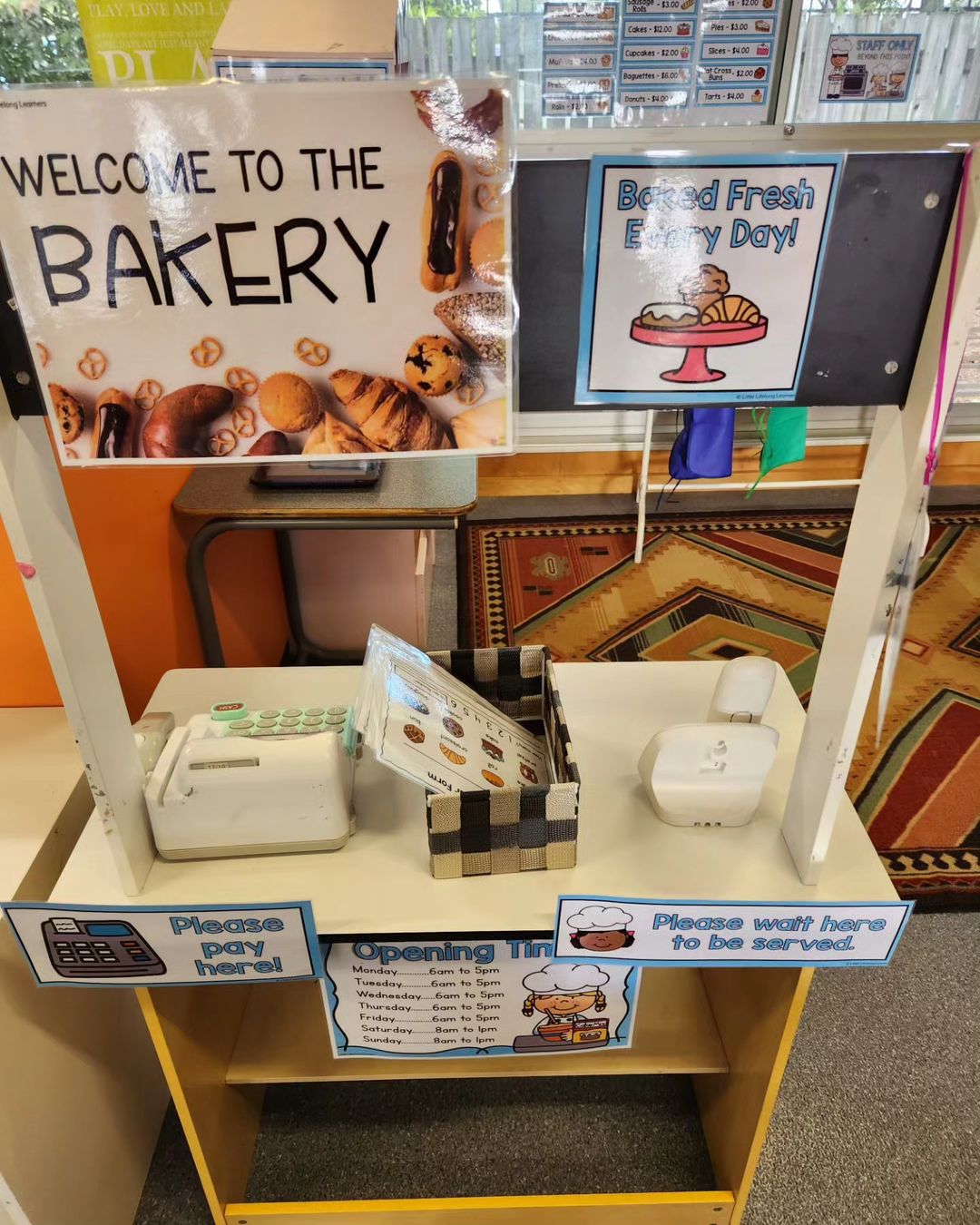 Kmart hacks for teachers: a wooden stall set up with a banner saying 'Welcome to the Bakery'