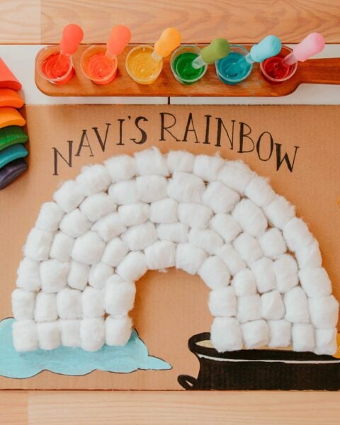 Cotton ball rainbow on brown paper background