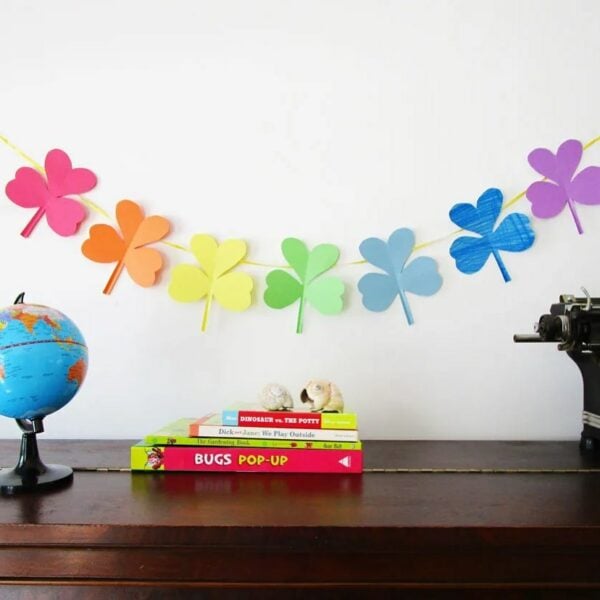 Shamrock Banner in rainbow colors on white wall.